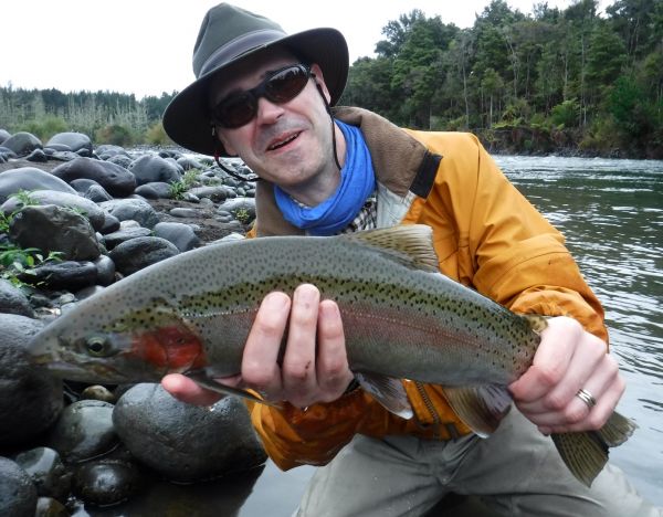 Daniel on vacation from Sweden with a rainbow from one of the Upper river pools.